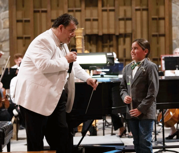 Conductor Brian Alhadeff and 11-year-old patron Grayson Soltero